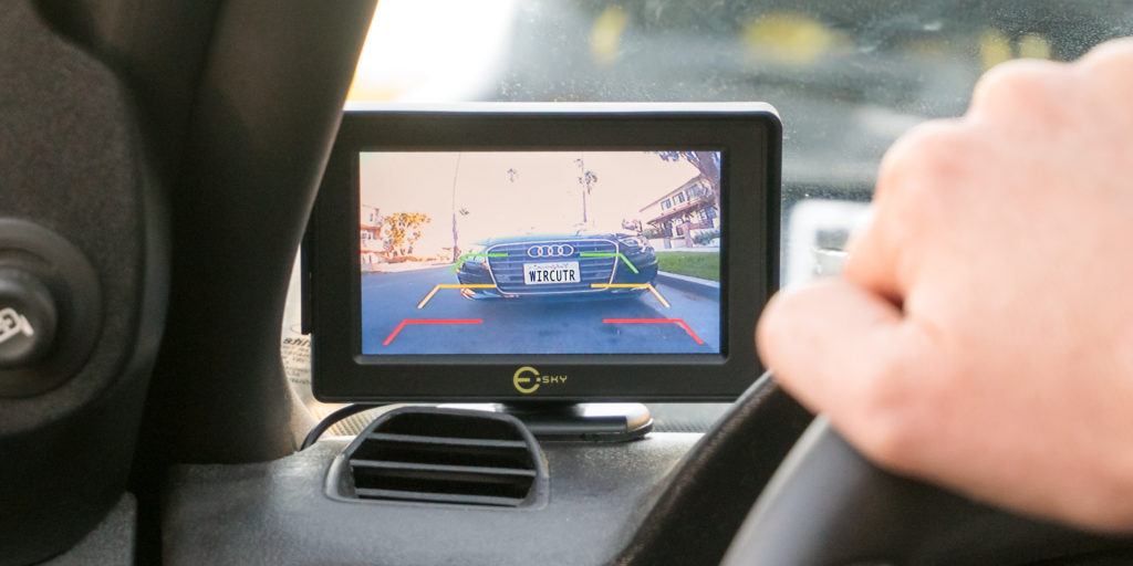 Vehicle safety system featuring a wide-angle rearview camera with night vision for enhanced visibility and safe maneuvering in low-light conditions